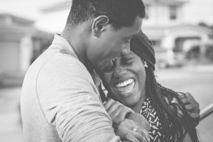 African American Husband and Wife Hugging and Smiling